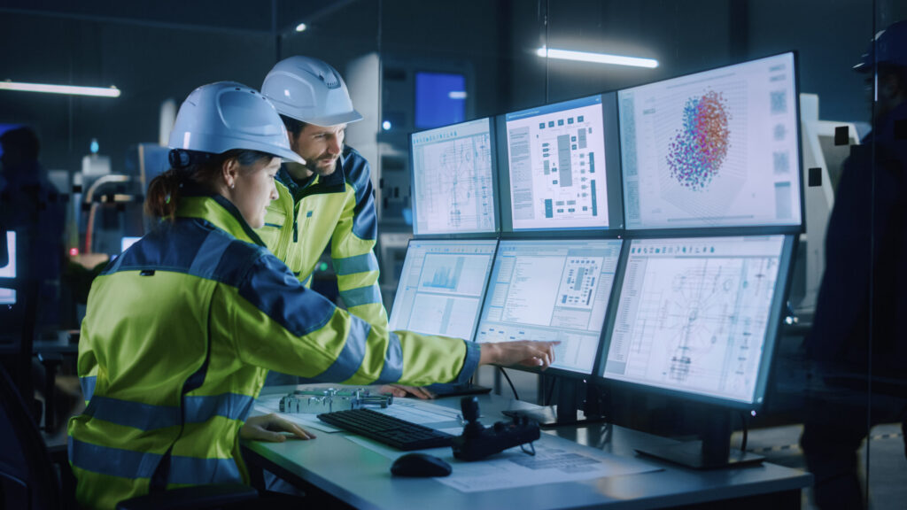 Two workers looking at 6 Ops monitors cyersecurity